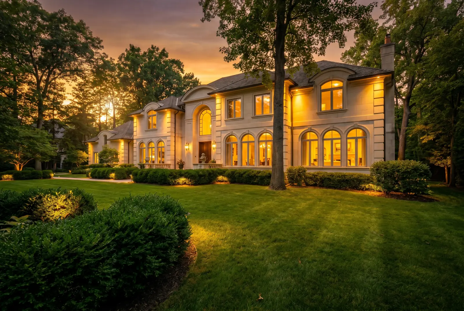 Luxury white residence nestled among lush green trees